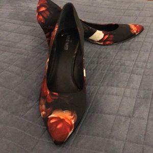 Red and cream floral heels with black background